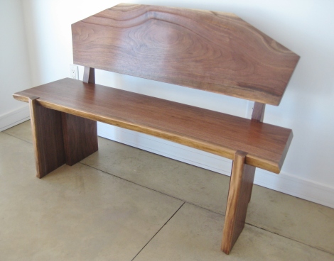 Walnut bench with contour shaping on the back